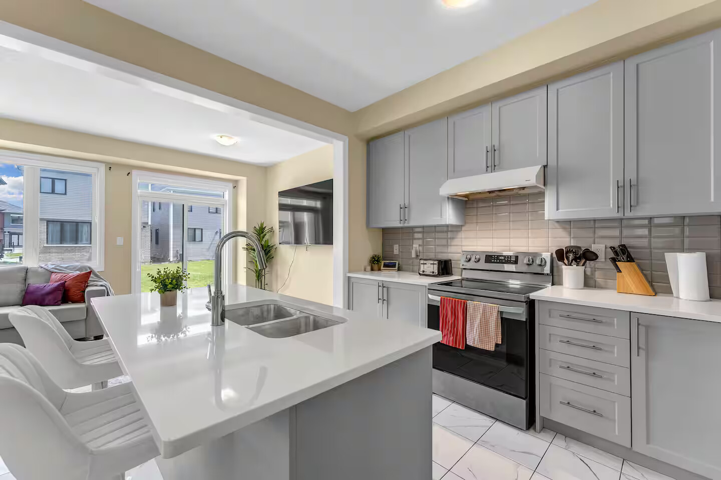 Kitchen with quartz island and stainless appliances